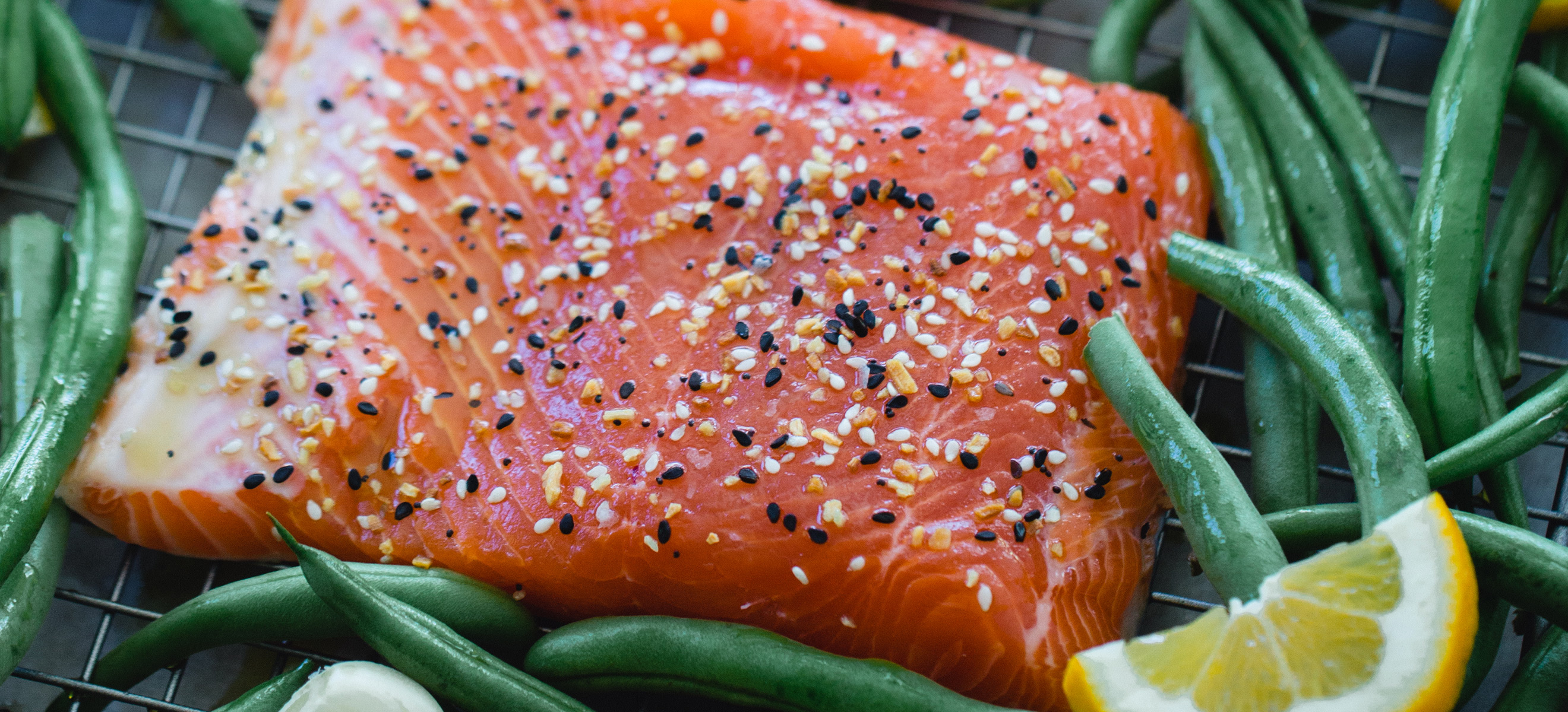 sliced king salmon over green beans 