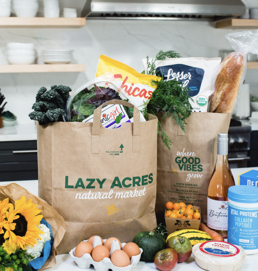 filled lazy acres grocery bags in the trunk of a car